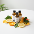 Three 15ml Citrus Grove Limb Wash bottles with fresh citrus slices